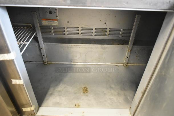 Beverage Air UCR72AY-23 stainless steel undercounter cooler interior, showing moderate wear and basic shelving setup.