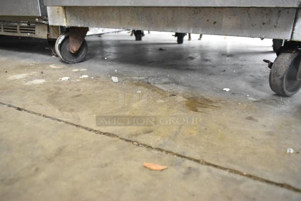 Continental 1FE stainless steel commercial freezer on casters, showing lower section. Poly-coated racks included.