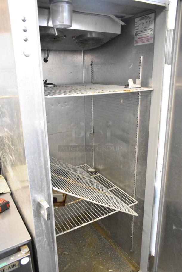 Continental 1FE stainless steel commercial single door reach-in freezer with poly coated racks, on casters, 115V, 1 phase.