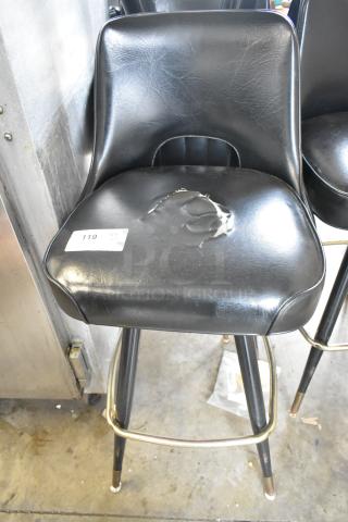 Black bar height stool with torn seat and metal legs, labeled "119". Signs of wear, part of 14-piece auction lot.