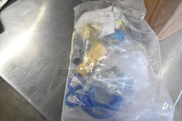 Brand new Dormont gas hose in packaging, minor scratches and dents visible, includes fittings, instruction label attached.