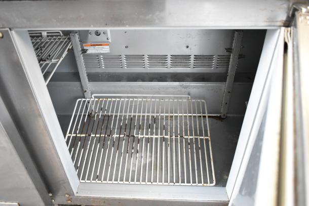 Beverage Air UCR72AY-23 stainless steel 3-door undercounter cooler interior, showing wire shelves and vent, 115V, 1 phase.