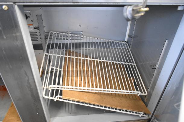 Beverage Air UCR48A-23 stainless steel 2-door undercounter cooler, open with wire shelving visible. 115 volts, 1 phase.