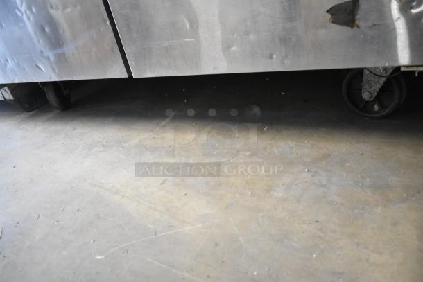 2016 Atosa MGF8406 stainless steel 2-door undercounter freezer on commercial casters. Notable exterior denting visible.