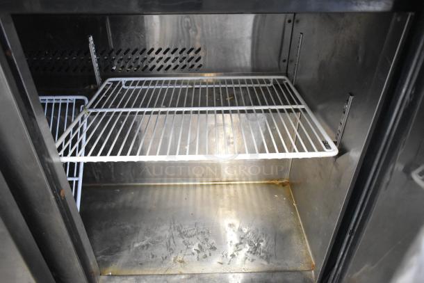 2016 Atosa MGF8406 stainless steel 2-door undercounter freezer interior, commercial-grade shelves, visible wear.