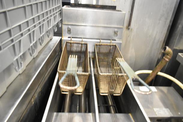 Pitco Frialator SG14T stainless steel commercial fryer with two metal baskets, natural gas powered, 100,000 BTU.