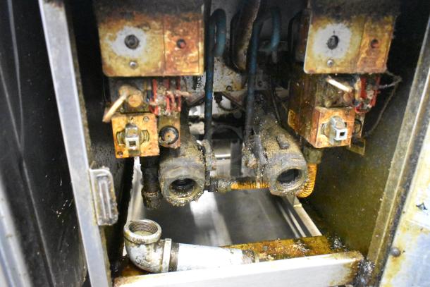 Pitco Frialator SG14T stainless steel natural gas fryer, worn condition, interior view with visible burners and pipes.