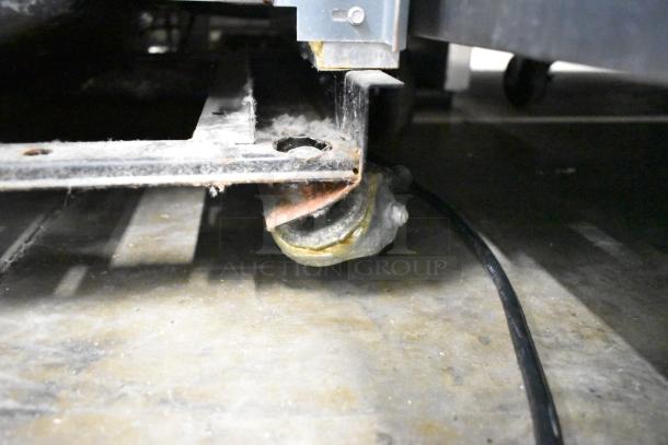 True T-19F single door reach-in freezer on a commercial caster, close-up detail showing wear, 115 volts, 1 phase.