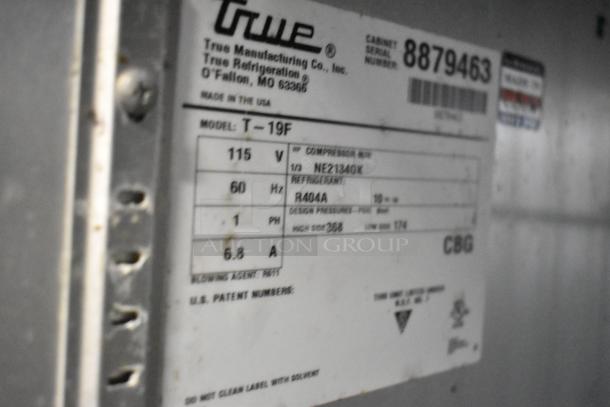 2016 True T-19F stainless steel commercial freezer label, featuring model and serial number details, voltage, and refrigerant type.