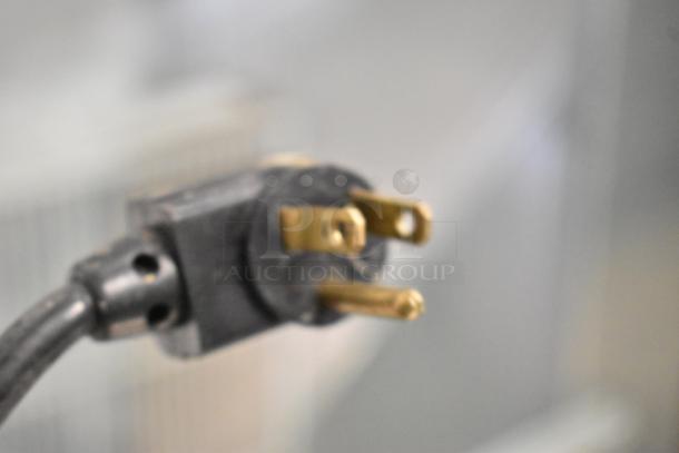 Close-up image of a power plug from the 2017 True TPP-67 Stainless Steel Commercial Pizza Prep Table.