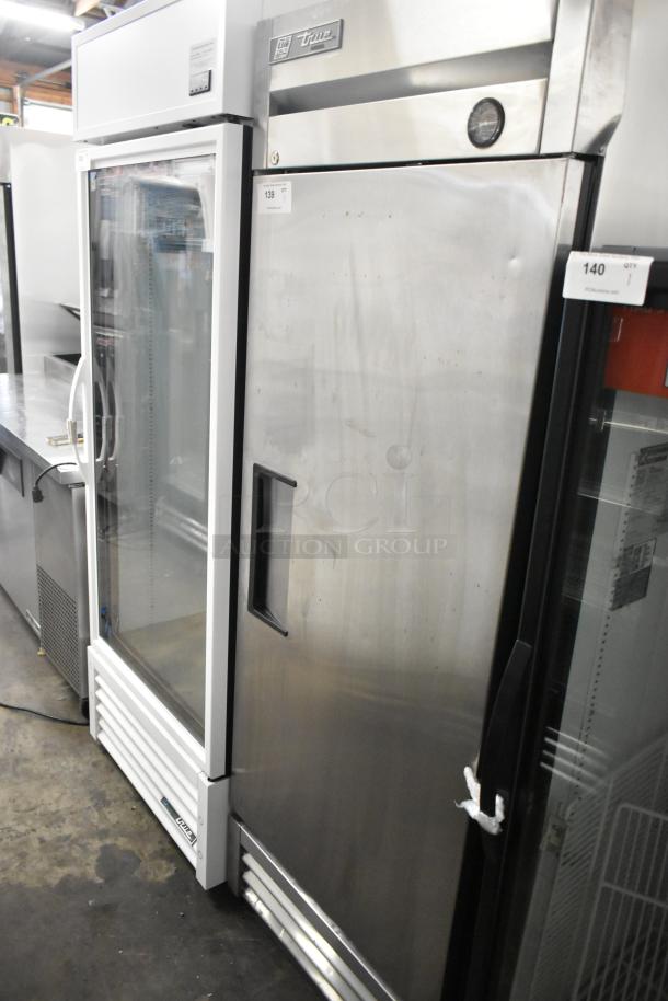 2017 True T-19F stainless steel commercial freezer, single door, with poly coated racks, 115V, 1 phase. Slight wear visible.