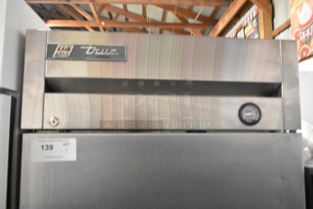 2017 True T-19F stainless steel commercial single door reach-in freezer with poly-coated racks. 115 Volts, 1 Phase.