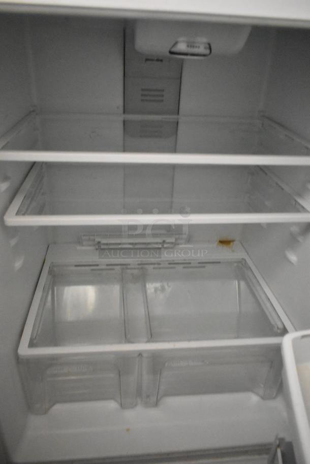 Maytag M1TXEGMYW01 metal single door reach-in cooler with freezer, 115 volts, 1 phase. Interior has glass shelves.