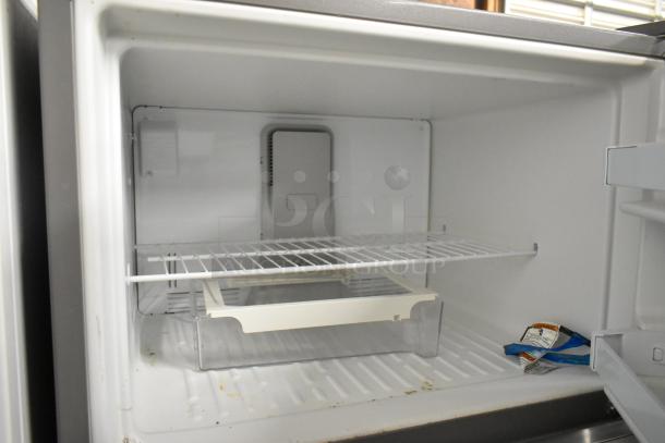 2018 Maytag WRT311FZDM01 stainless steel fridge with freezer, 115V, 1 phase. Interior view: wire shelf, drawer, door storage.