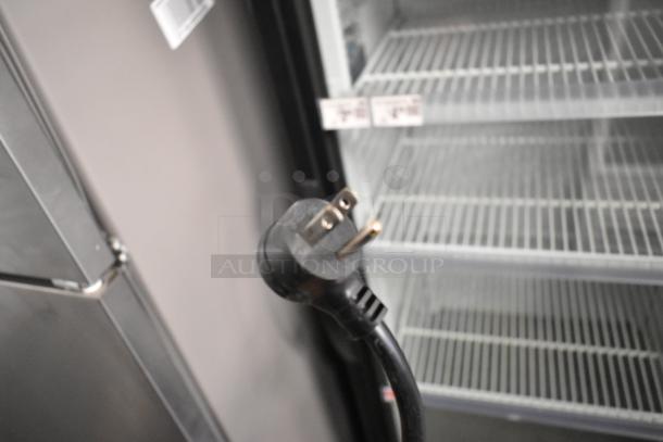 2020 True GDM-12-HC cooler merchandiser with single glass door, poly-coated racks, and 115V plug, showing interior racks.
