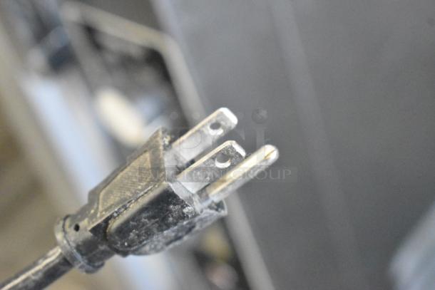 Close-up of a power plug from a 2019 IDW G4-HD234B Metal Mini Cooler Merchandiser, 115 Volts, 1 Phase.