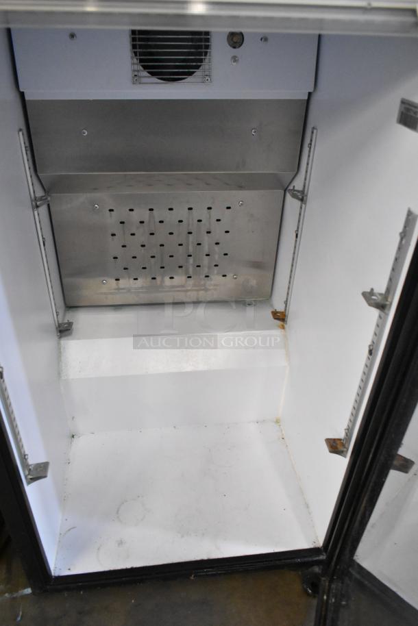 QBD DC6H Metal Mini Cooler Merchandiser, 115V, 1 Phase. Interior view showing shelving brackets and cooling vent.