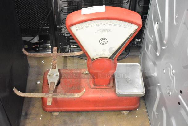 San Giorgio metal countertop bakery scale with red body and silver tray, visible rust on components. Model details on dial.