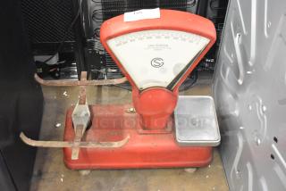 San Giorgio metal countertop bakery scale with red body and silver tray, visible rust on components. Model details on dial.