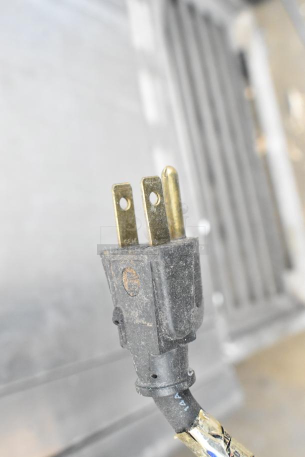 A close-up of a plug for the Baxter OV310G stainless steel commercial gas oven, showcasing its electrical connection.