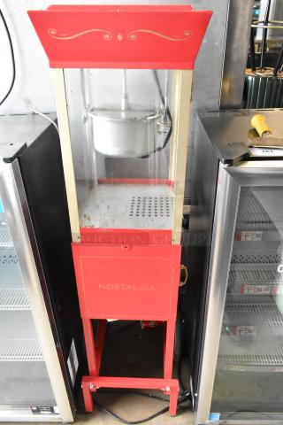 Nostalgia CCP510 vintage-style popcorn cart, red metal, 120 volts. Used condition, visible branding "Nostalgia" on front panel.