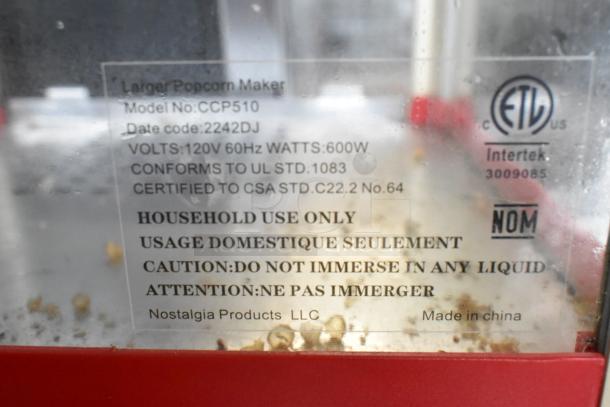 Close-up of Nostalgia CCP510 Popcorn Cart label, showing 120V specs, model info, and safety cautions. Made in China.