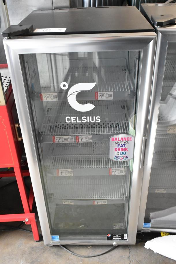 2021 IDW G4-H0234B Metal Mini Cooler Merchandiser with glass door, branded "Celsius," voltage 110-120V, 1 phase, good condition.
