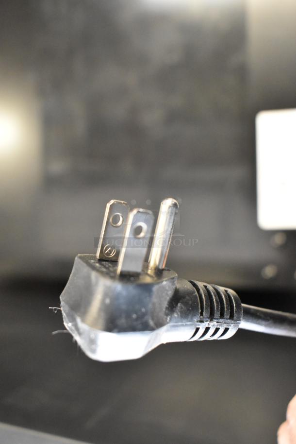 Plug of Arctic King ARV115B1AST Mini Cooler, 110-120V, 1 Phase. Close-up showing prongs and cord detail.