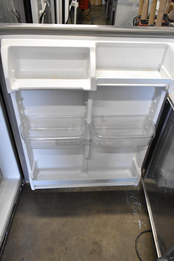 Whirlpool stainless steel single door cooler with freezer interior view, features adjustable shelves, 115 volts, 1 phase.