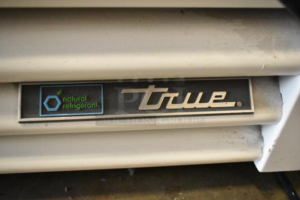 True TSCI-600R-G-PH cooler; silver metal finish, single door, poly-coated racks, "natural refrigerant" label visible.