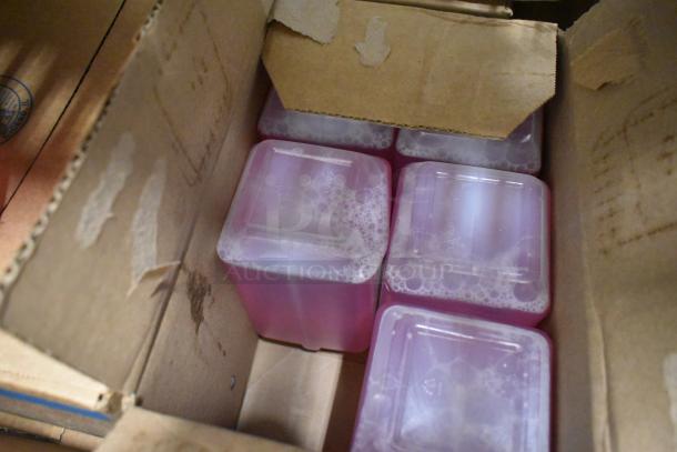 Box containing multiple pink containers of Scott Foam Skin Cleanser, sealed and neatly packed.
