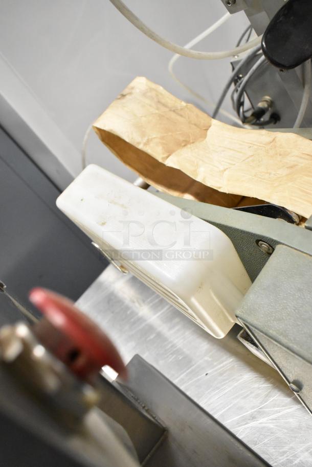 Marsh Taper 5HT gummed tape dispenser, visible wear, features a roll of brown tape, manual controls.