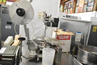 Universal Metal Countertop Unit featuring metal components, various attachments, and visible cords in used condition.