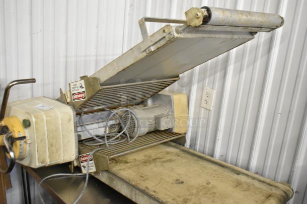 Rondo Seewer metal commercial floor style reversible dough sheeter, worn condition, visible safety labels.