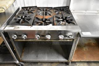 Jade Range JSR-6 commercial gas range, 6 burners, stainless steel, under shelf, visible wear, durable kitchen equipment.