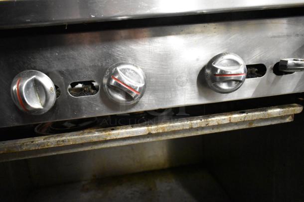 Jade Range JSR-6 commercial gas range controls, stainless steel, shows moderate use, visible markings on knobs.