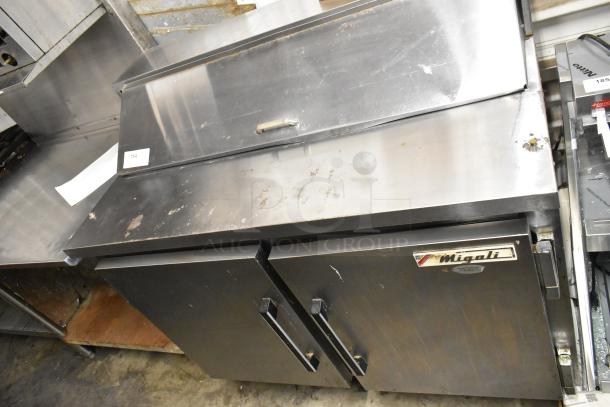 Migali CA412 stainless steel commercial sandwich salad prep table. Model CA412, 115V, 1 Phase. Signs of wear, logo visible.