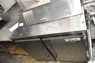 Migali CA412 stainless steel commercial sandwich salad prep table. Model CA412, 115V, 1 Phase. Signs of wear, logo visible.