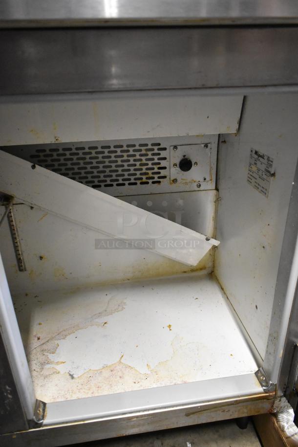 Migali CA412 stainless steel prep table interior. Visible wear and markings. Labels show model details. 115 Volts, 1 Phase.