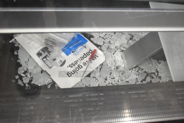 Brand new Avantco metal deli display case merchandiser with broken glass. 115 volts, 1 phase. Visible glass shards.