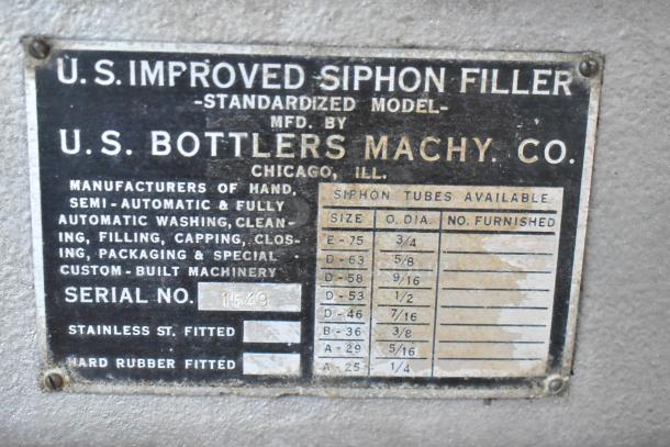 US Bottlers Machy Co metal siphon filler label showing model details, serial number 1549. Offers various siphon tube sizes.