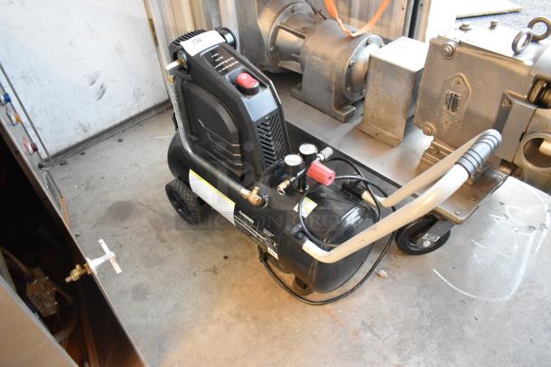 Husky 8 Gal. 150 PSI portable air compressor, model 0300813A, with rubber wheels, electric, oil-free, in good condition.