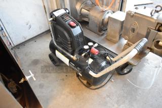 Husky 8 Gal. 150 PSI portable air compressor, model 0300813A, with rubber wheels, electric, oil-free, in good condition.