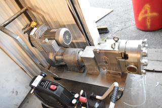 Waukesha Pump Metal Compressor, industrial-grade, metal construction, mounted on base. Signs of use, with attached motor.