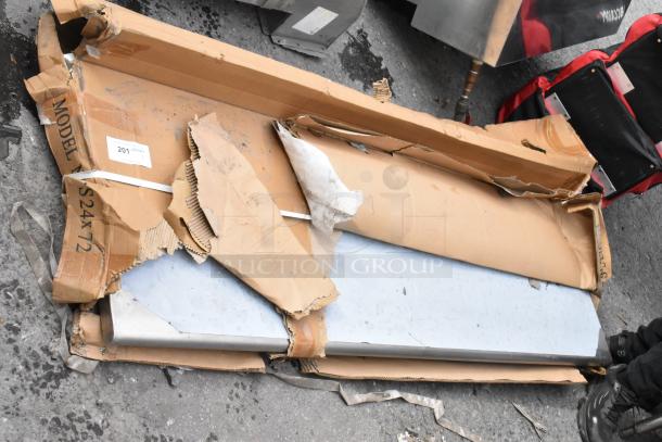 BRAND NEW B5S-S24X72 stainless steel table, scratch and dent condition, partially unpacked with damaged packaging visible.