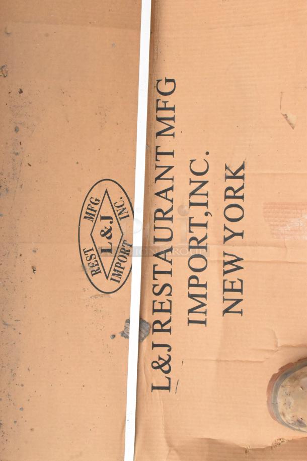 Alt text: Cardboard packaging with "L&J Restaurant MFG Import, Inc. New York" logo containing a brand new B5S-S24X72 stainless steel table.