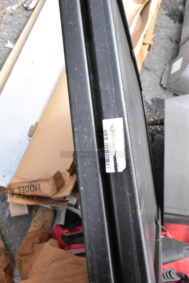 Black poly A-frame sidewalk sign, visible label with barcode; appears in used condition with some surface wear.