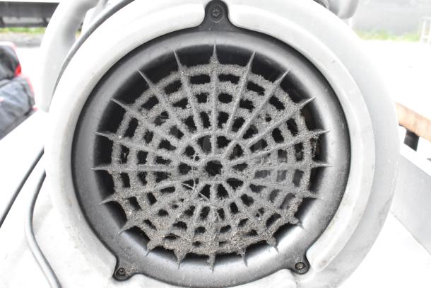 B Air VP-50 black poly air mover fan, used condition, 115 volts, 1 phase, close-up of vent with dust accumulation.