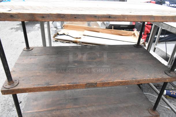 Three-tier wooden and metal cart on commercial casters, featuring rustic wood shelves, sturdy metal poles, used condition.