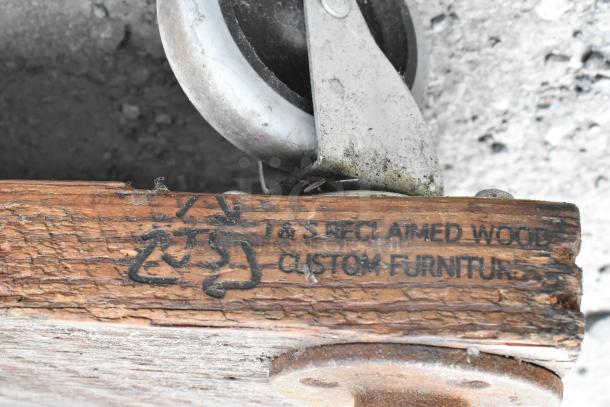 Wooden and metal 3-tier cart with commercial casters. "T&S Reclaimed Wood Custom Furniture" marking visible.